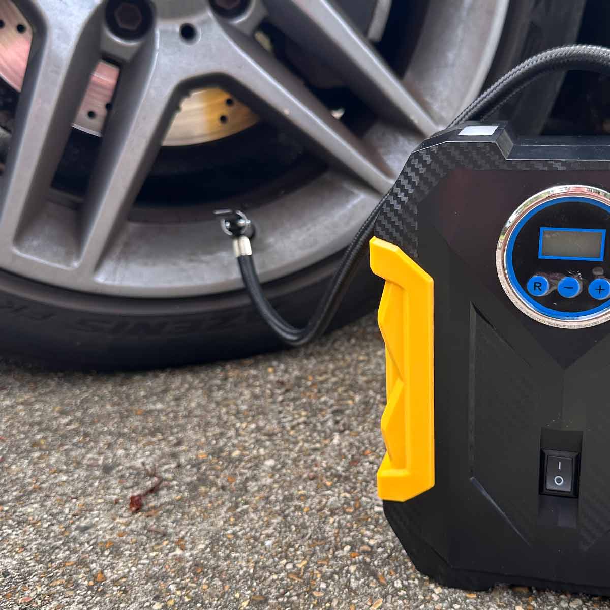 12 volt air compressor pumping up tyre