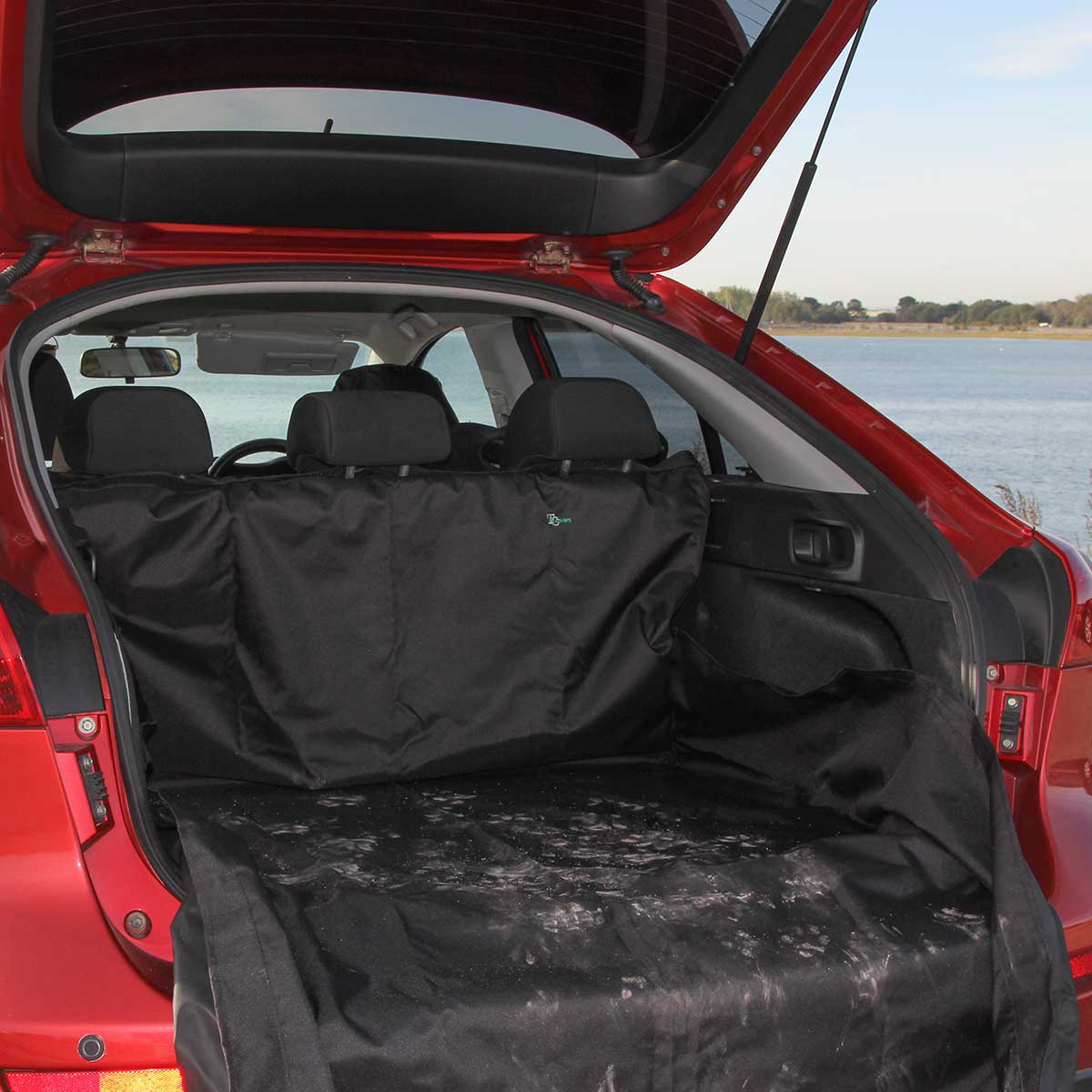 Car boot cover protecing car boot from muddy/sandy paw prints.